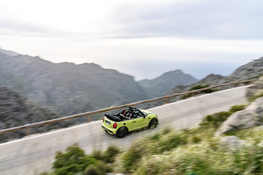 A MINI Cooper Convertible cruises along a mountain pass in Cape Town.